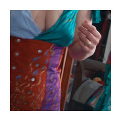 a photograph of a woman wearing a multicolored satin and taffeta buttoned corslet and dress