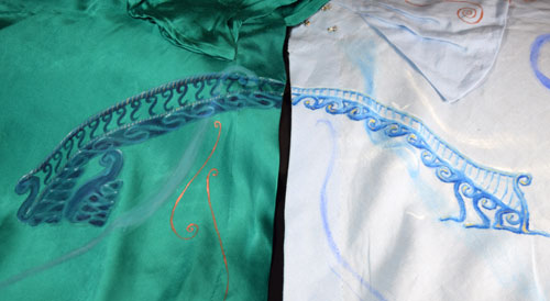 A painting of a bridge spanning peacock green satin and pale blue linen