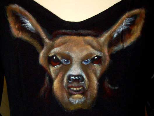 a screaming man's face hidden inside a deer painted on the front of the top