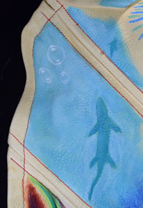 a detail of a silhouetted sea creature in azure blue water